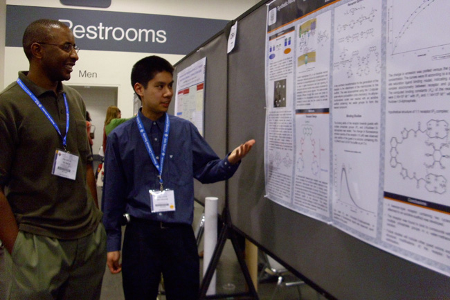 Chi-Linh wows a visitor to his poster with his sensor work